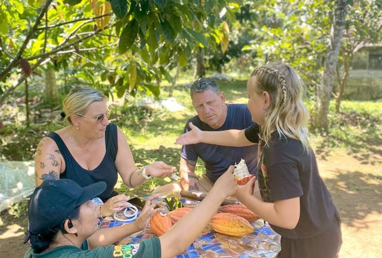 Guide explaining cacao trees at Desa Coklat Bali