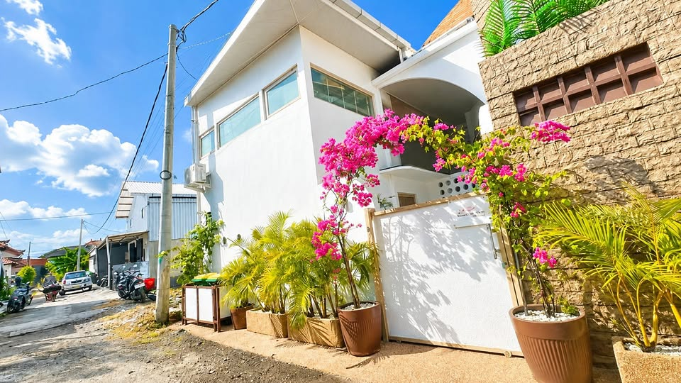 Sakura Villa exterior, white building with garden entrance